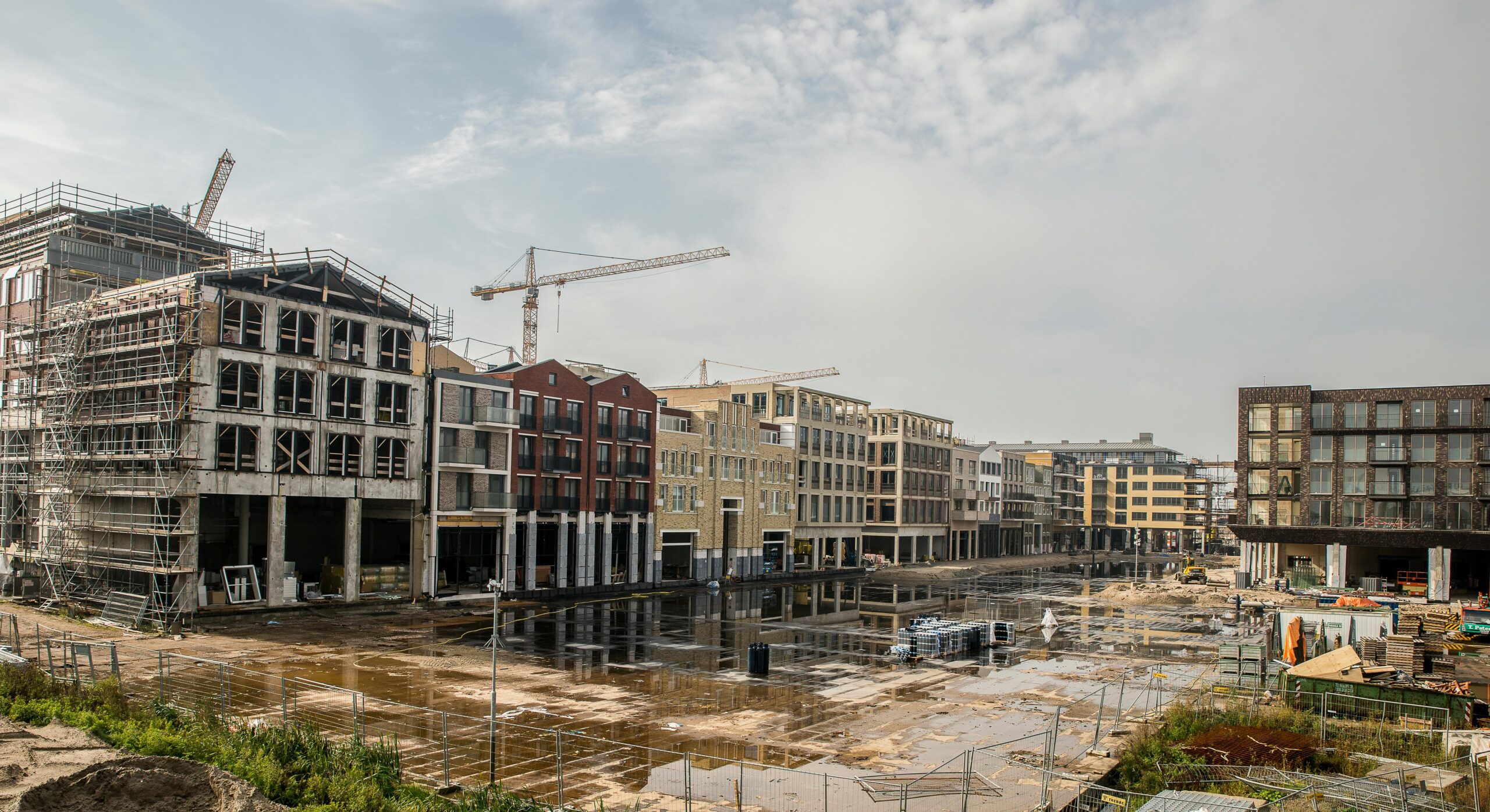 A modern construction site with buildings and cranes showcasing urban development.